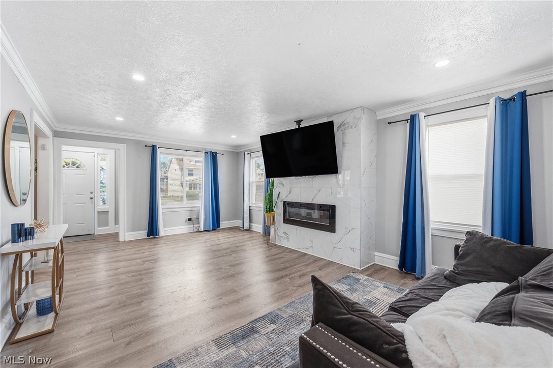 3386 Sylvanhurst Road Cleveland Heights, OH 44112 - Photo 2 of 46 Spacious living area featuring wood-finish flooring, recessed lighting, and a modern fireplace with a marble-look surround