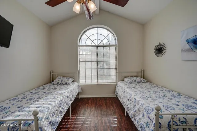 a bedroom with a bed and a chandelier