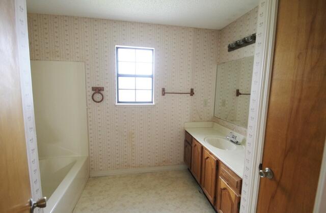 465 Ridge Lake Road Crestview, FL 32536 - Photo 19 of 34 a bathroom with a tub sink and mirror