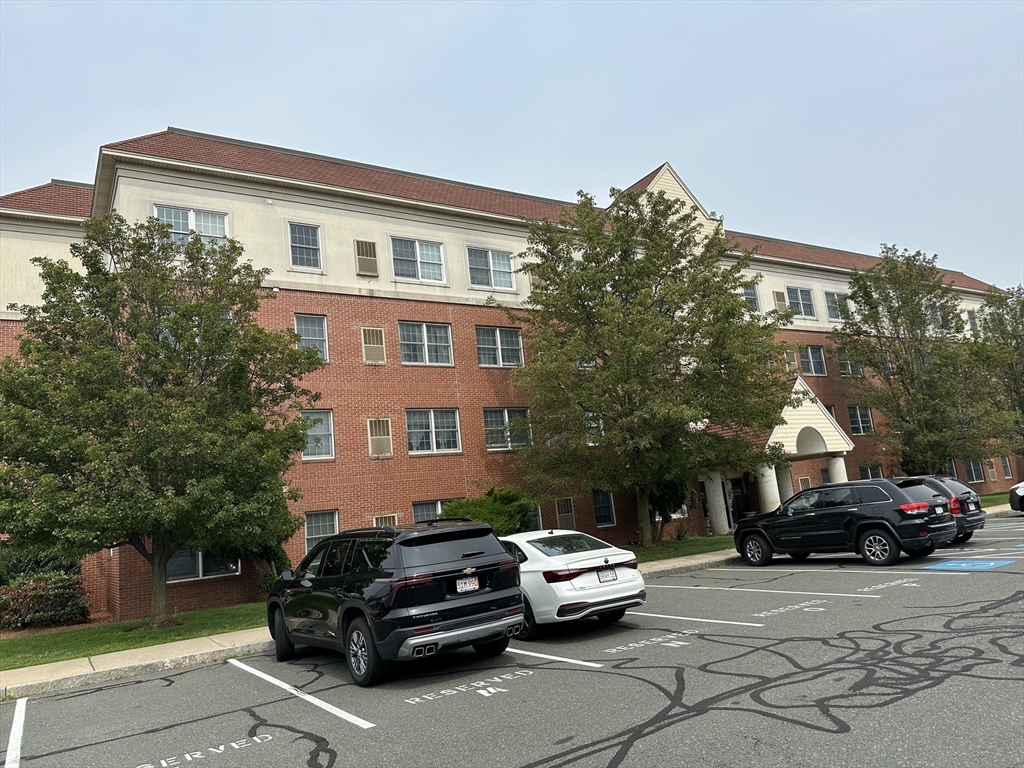 a car parked in front of a white house