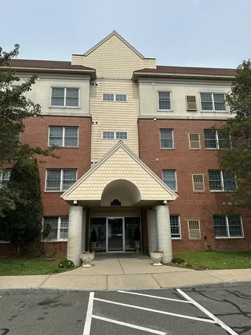 a front view of a house with a yard and a garage