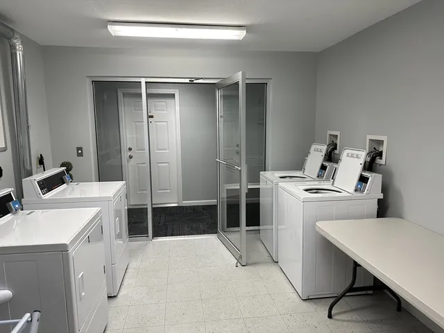 a kitchen with a stove a sink a table and chairs