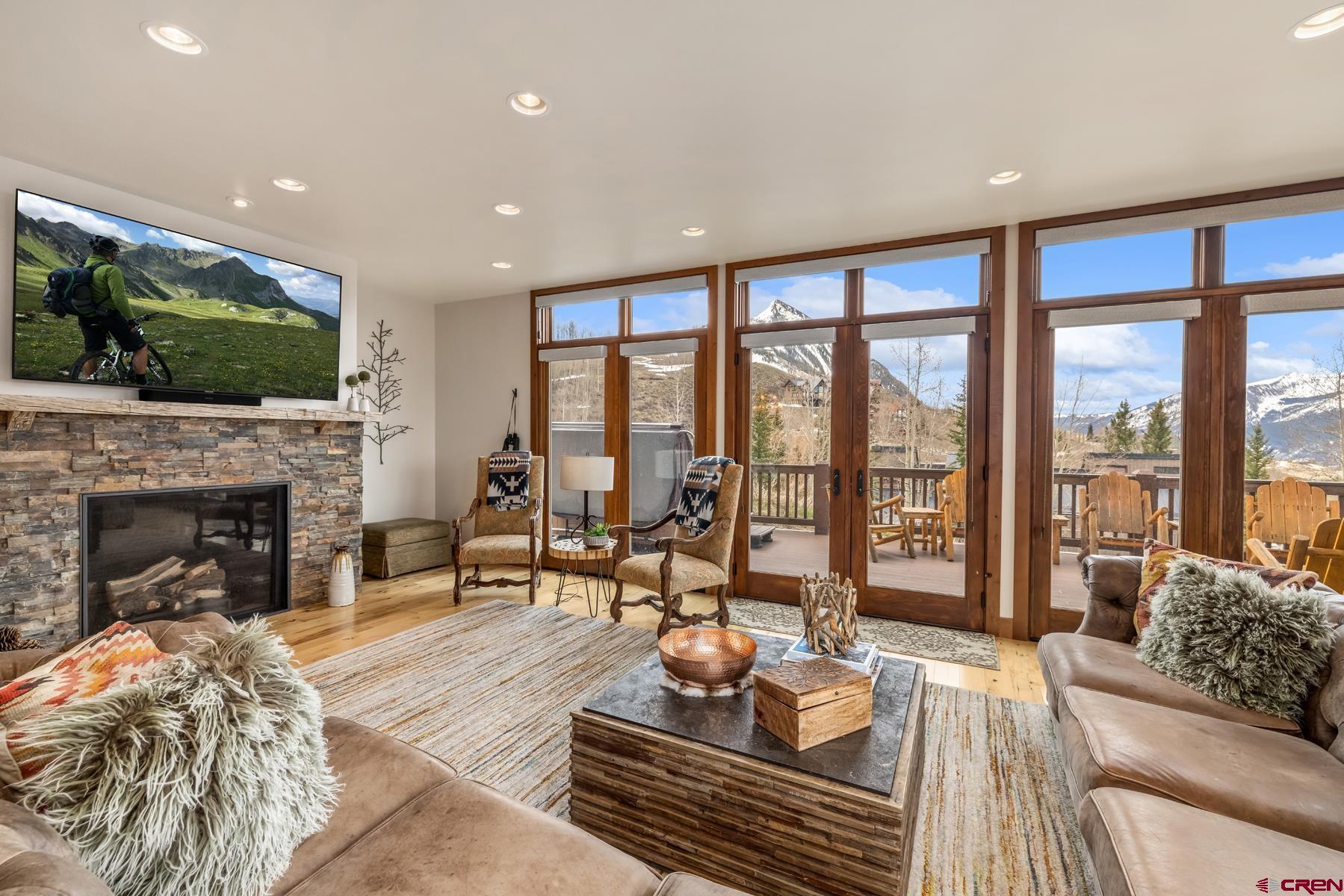 32 Cinnamon Mountain Road Crested Butte, CO 81225 - Photo 8 of 44 a living room with furniture fireplace and a large window