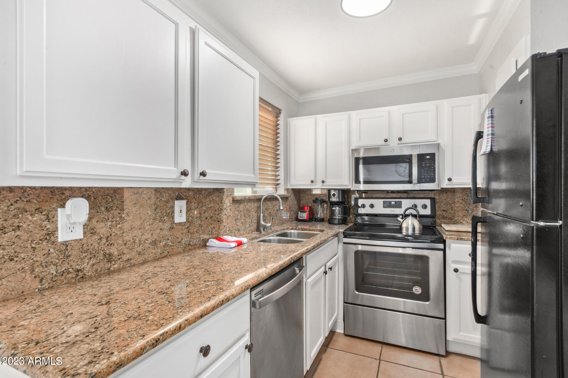 4401 North 12th Street, Unit 120 Phoenix, AZ 85014 - Photo 6 of 21 a kitchen with stainless steel appliances granite countertop a sink stove and refrigerator