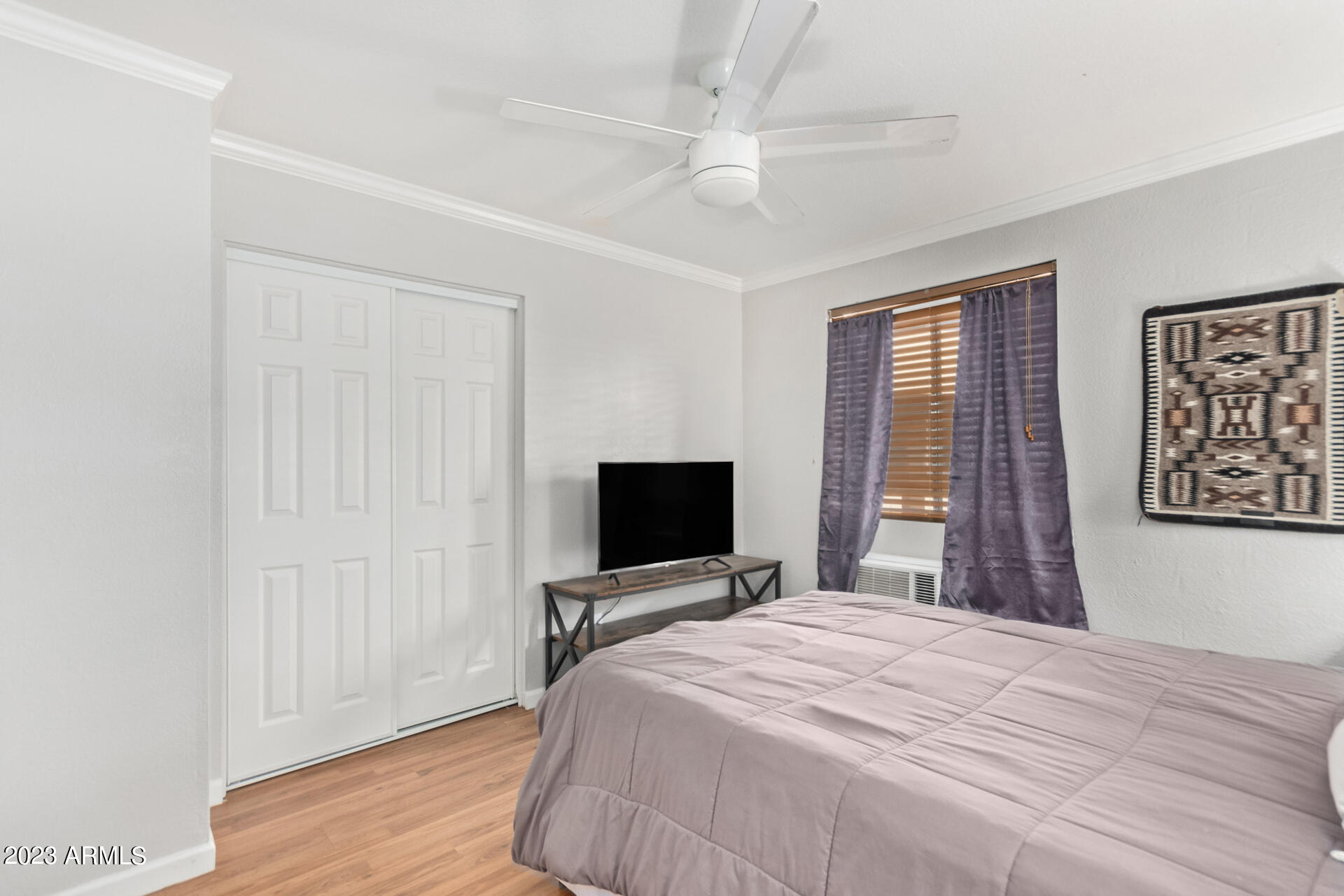 4401 North 12th Street, Unit 120 Phoenix, AZ 85014 - Photo 10 of 21 a bedroom with a bed and a flat screen tv