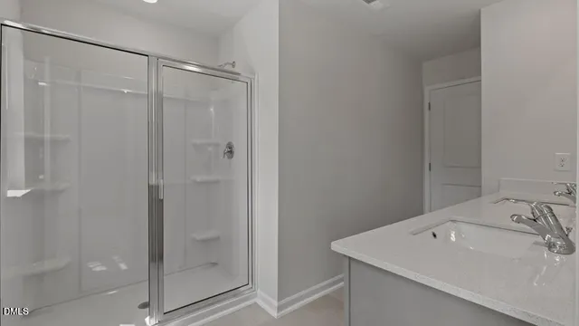 a bathroom with a sink and shower