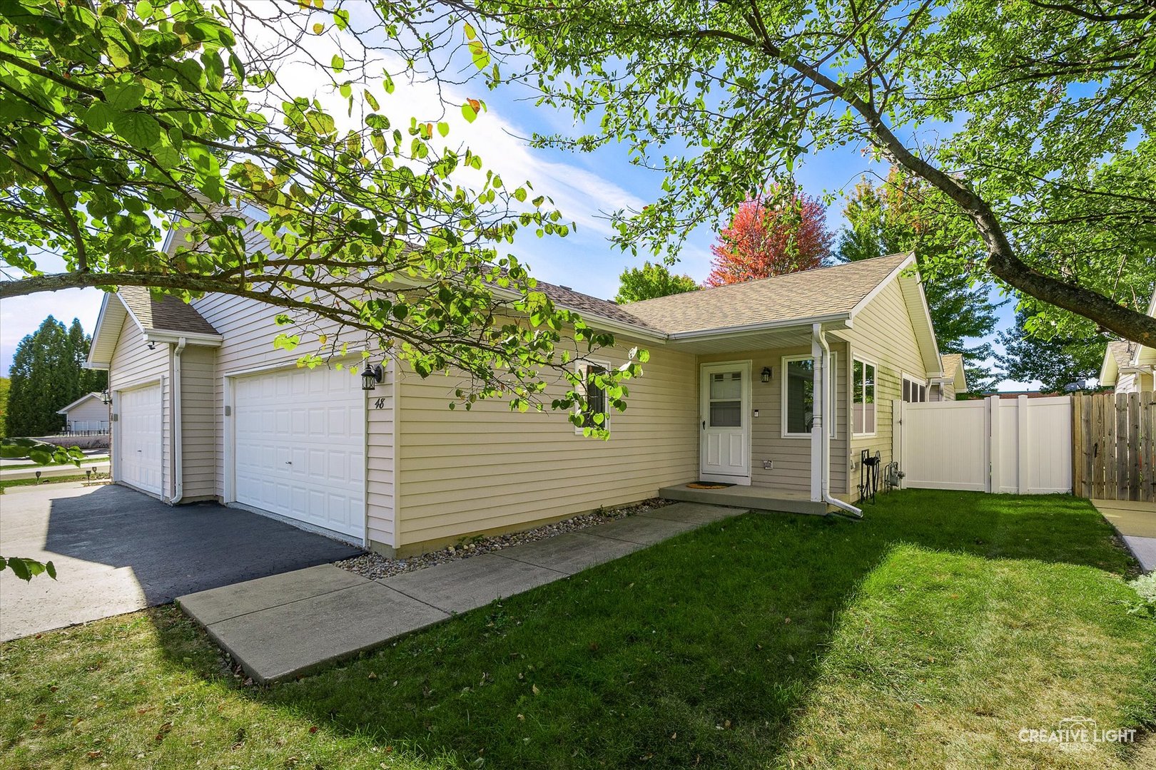 48 Silver Trail North Aurora, IL 60542 - Photo 1 of 29 a view of a white house next to a yard with a large tree