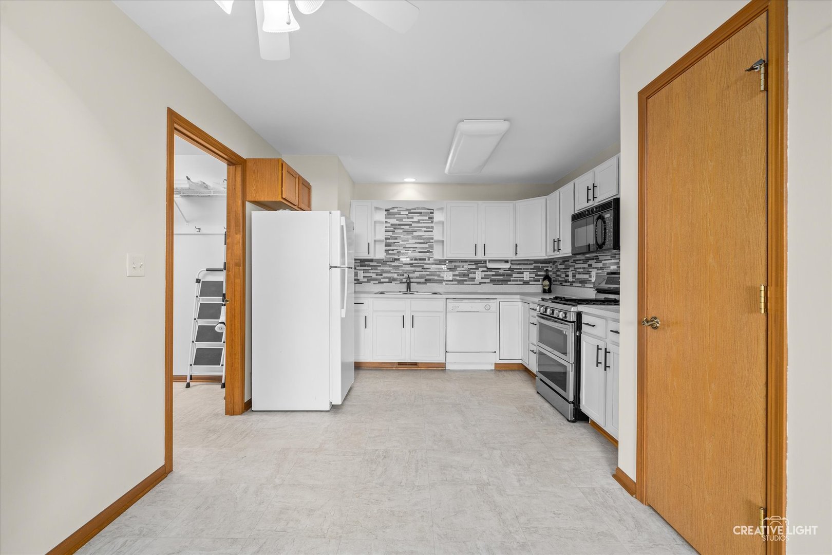 48 Silver Trail North Aurora, IL 60542 - Photo 5 of 29 a kitchen with white cabinets and white appliances