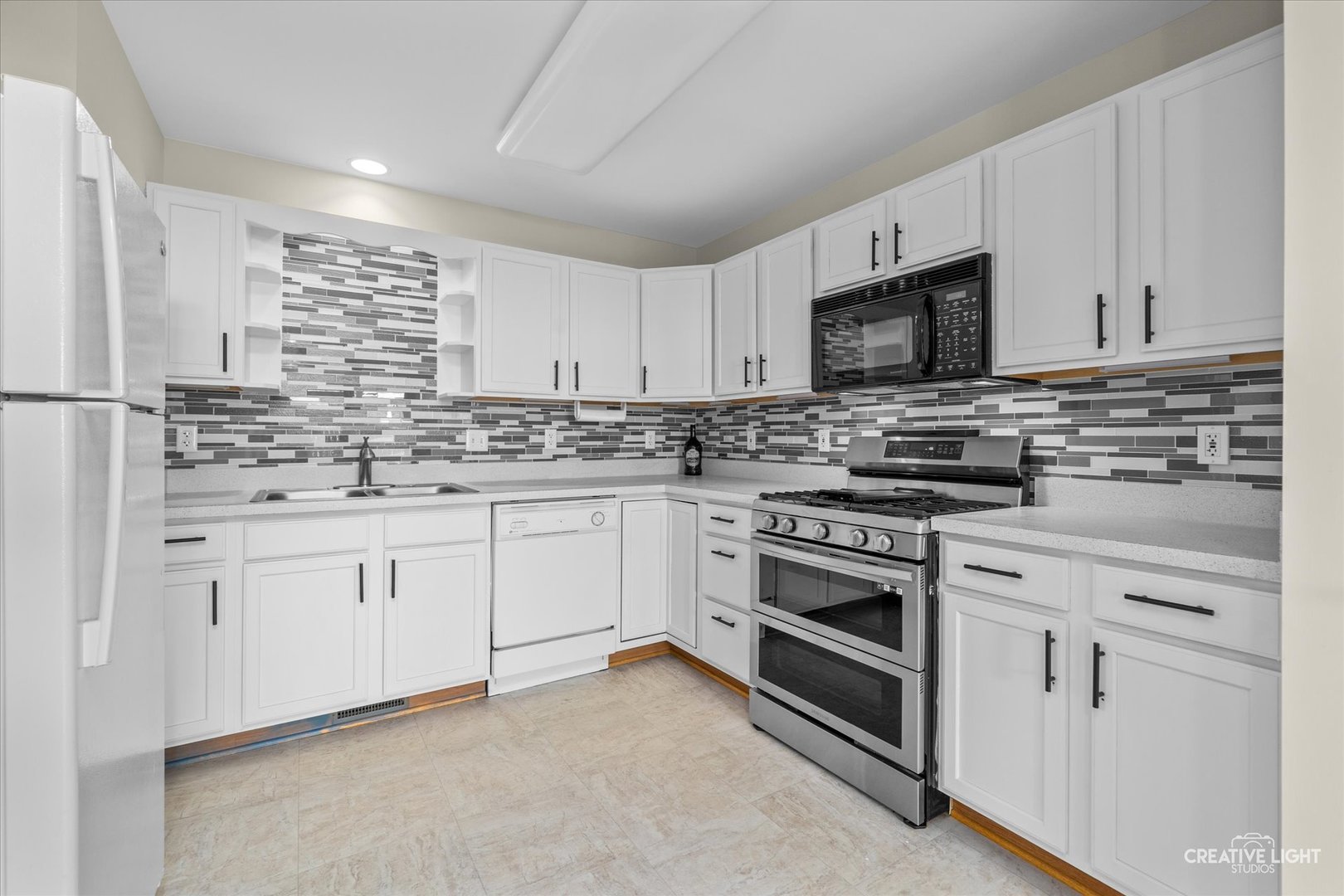 48 Silver Trail North Aurora, IL 60542 - Photo 6 of 29 a kitchen with granite countertop white cabinets and stainless steel appliances
