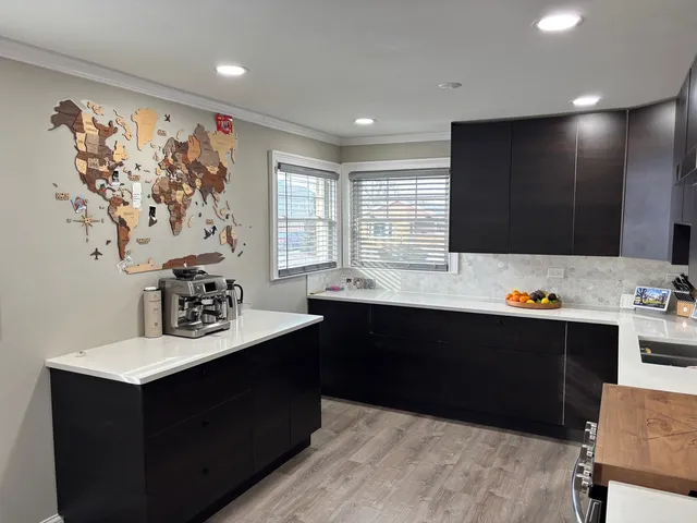 a kitchen with stainless steel appliances granite countertop a refrigerator and a stove top oven