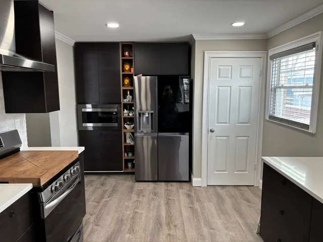 a bathroom with a sink a toilet a mirror and shower