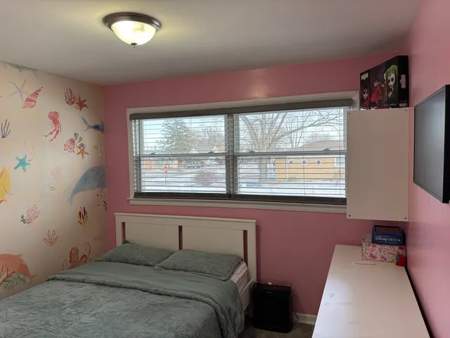 a bedroom with bed and closet