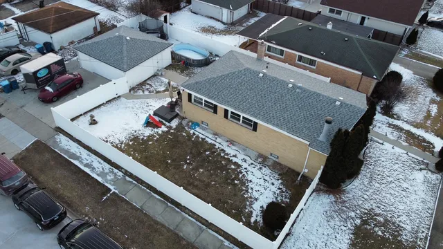 an aerial view of a house with a floor to ceiling window