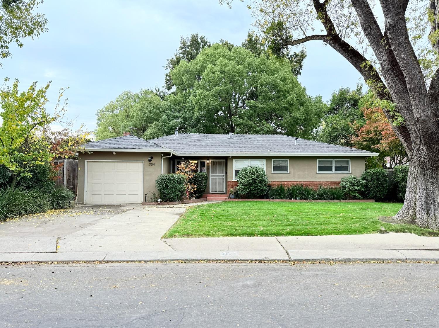 a front view of a house with a yard and a garage
