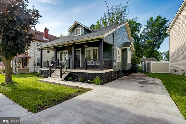 a view of a house with a yard and sitting area