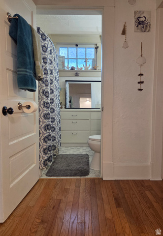 142 West 400 North Logan, UT 84321 - Photo 21 of 35 Bathroom featuring a built-in vanity with a countertop and under-sink storage, a window providing natural light, and a toilet