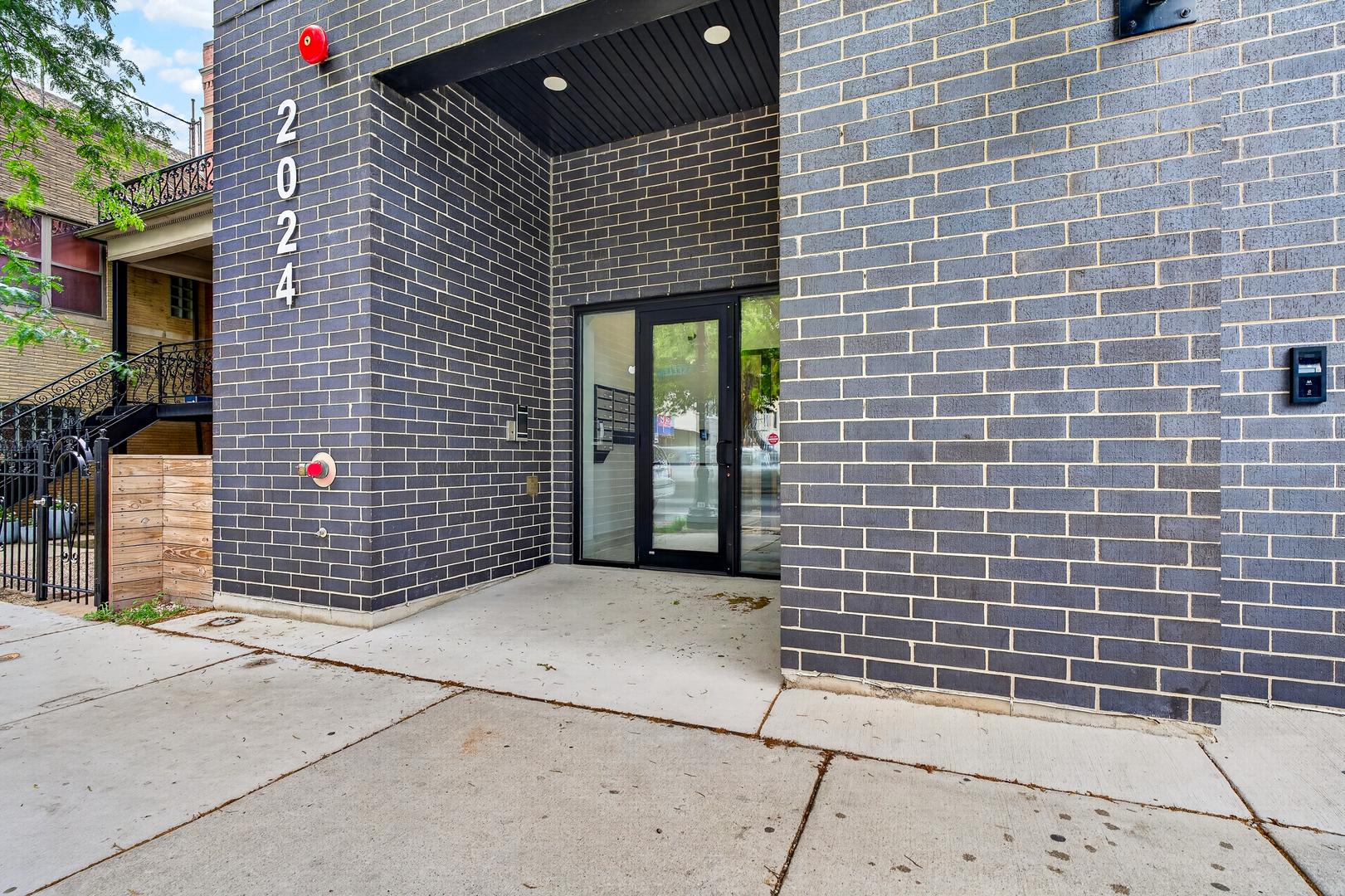 2024 West Irving Park Road, Unit 302 Chicago, IL 60618 - Photo 2 of 32 a front view of a house with glass door
