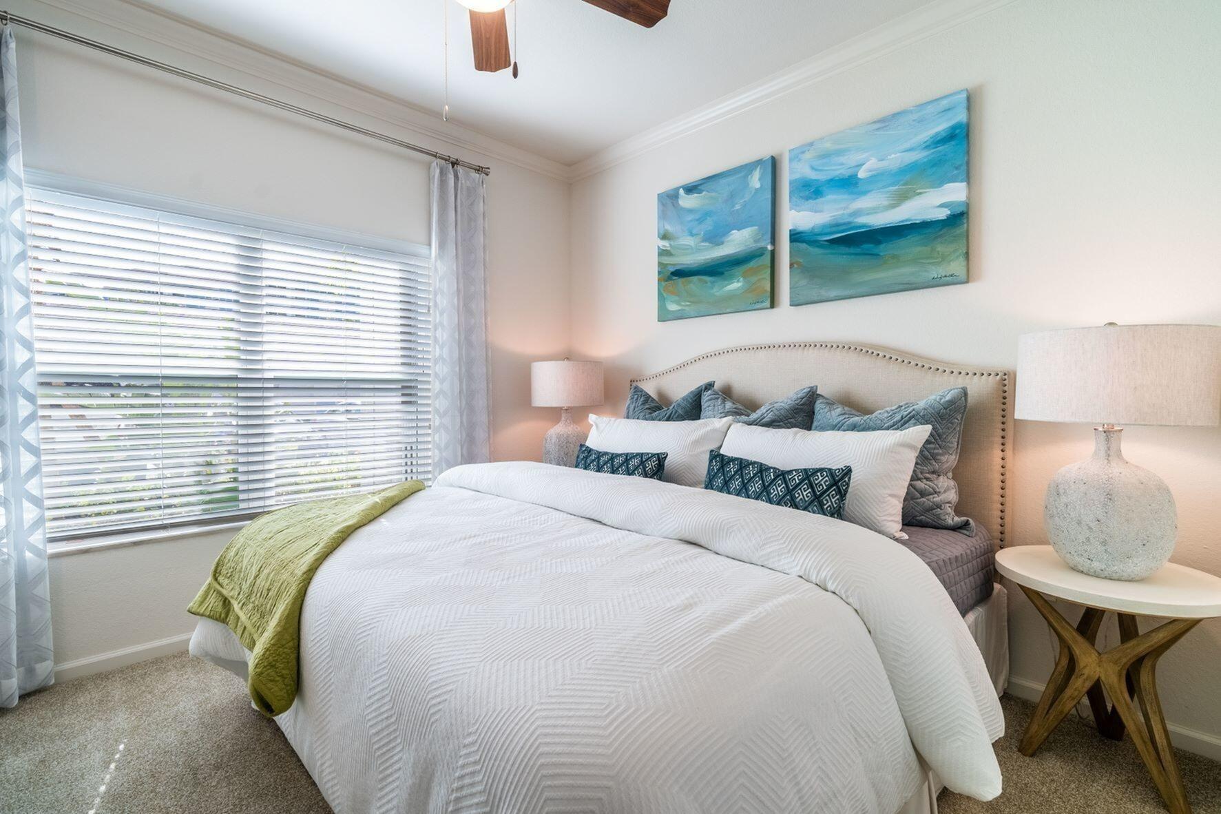 1924 Northwest Federal Highway, Unit 2317 Stuart, FL 34994 - Photo 7 of 15 a bedroom with a bed and a painting on the wall