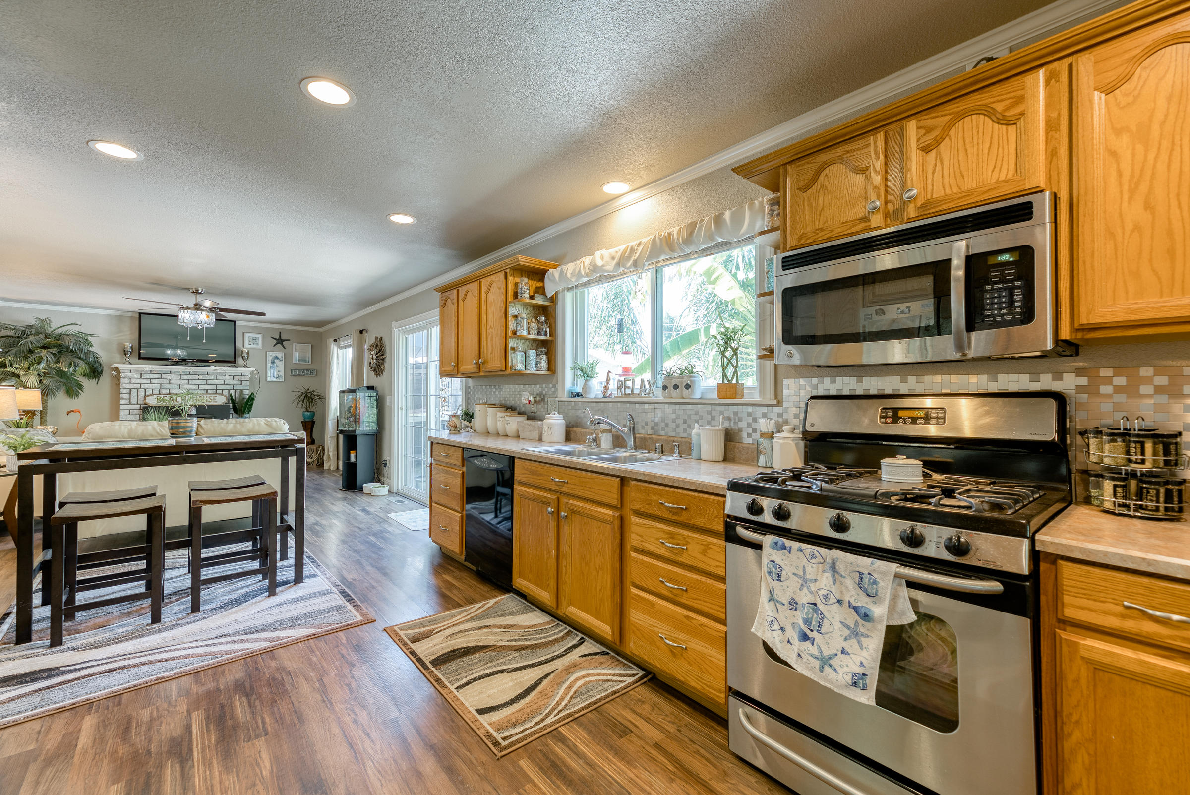 2016 Canyon Road Redding, CA 96001 - Photo 10 of 35 a kitchen with stainless steel appliances kitchen island granite countertop a stove a sink and a microwave