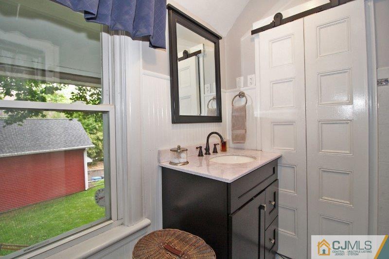 76 Rector Street Metuchen, NJ 08840 - Photo 12 of 25 a bathroom with a sink a toilet and a mirror