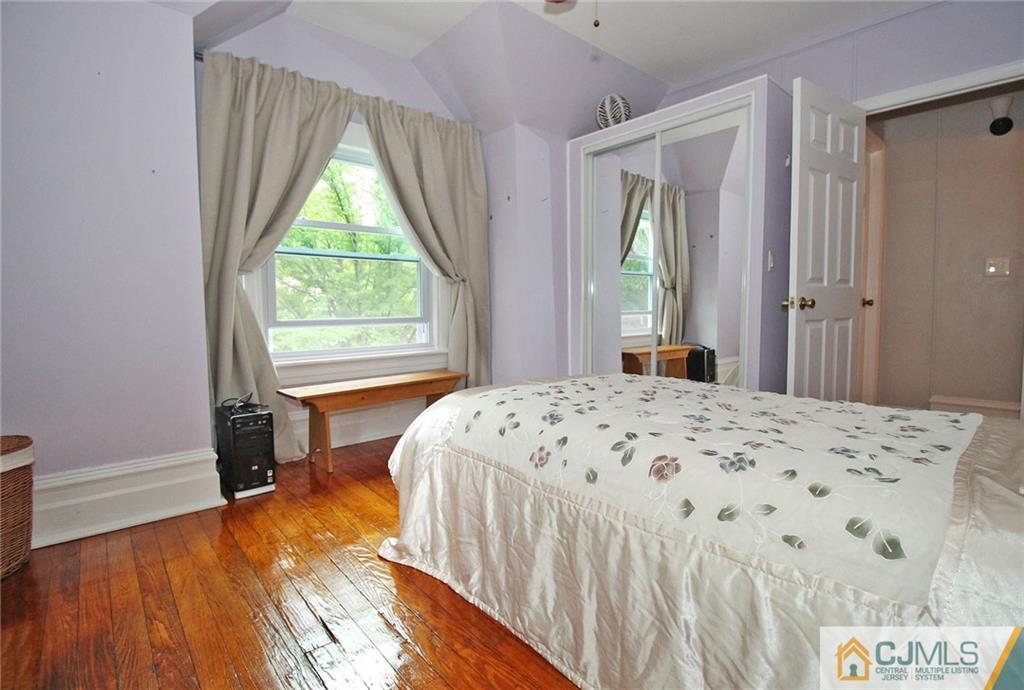 76 Rector Street Metuchen, NJ 08840 - Photo 14 of 25 a bedroom with a bed and a dresser next to a window