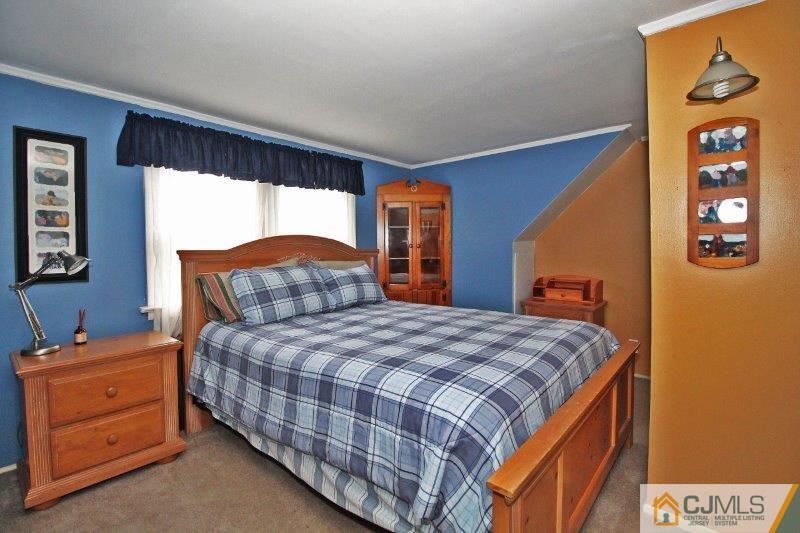 76 Rector Street Metuchen, NJ 08840 - Photo 15 of 25 a bedroom with a bed and a dresser