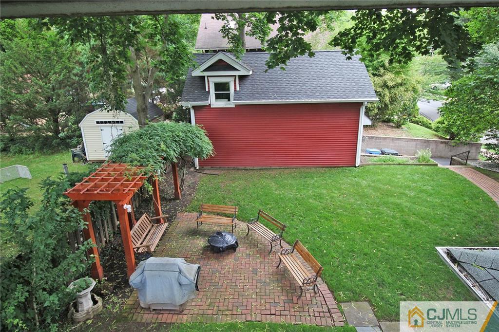 76 Rector Street Metuchen, NJ 08840 - Photo 18 of 25 a backyard of a house with table and chairs