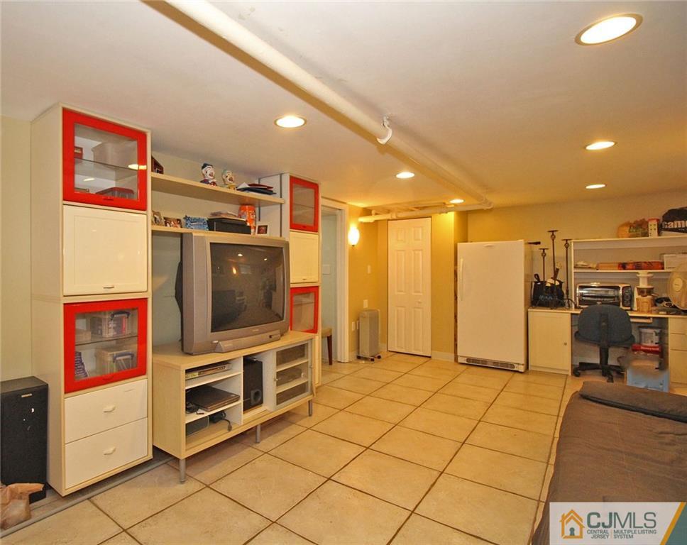 76 Rector Street Metuchen, NJ 08840 - Photo 22 of 25 a open kitchen with stainless steel appliances kitchen island granite countertop a refrigerator and a stove top oven
