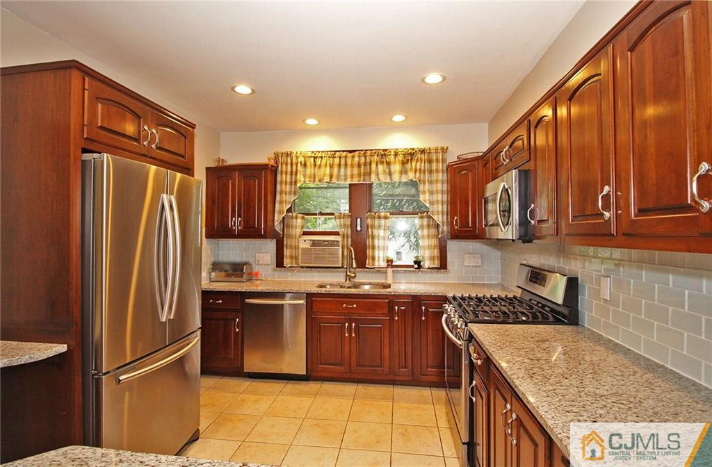 76 Rector Street Metuchen, NJ 08840 - Photo 5 of 25 a kitchen with stainless steel appliances granite countertop a refrigerator a stove and a sink