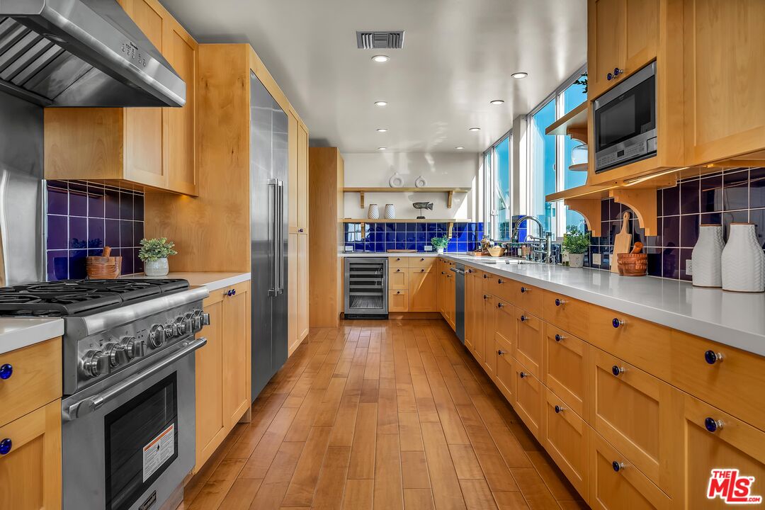 4 Lighthouse Street, Unit 13 Marina del Rey, CA 90292 - Photo 8 of 35 a kitchen with stainless steel appliances granite countertop a stove a sink and a refrigerator