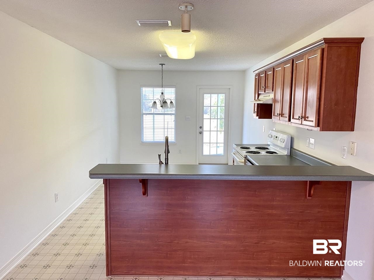 16420 Absalom Street Foley, AL 36535 - Photo 3 of 18 Kitchen featuring sink, white electric range, stainless steel dishwasher, kitchen peninsula, and a textured ceiling