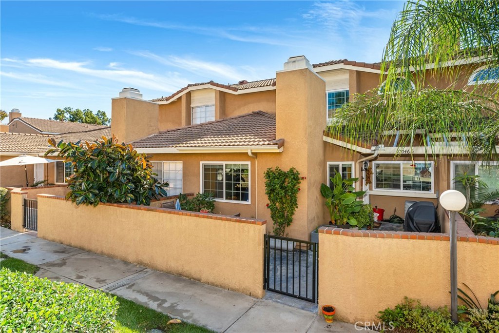 10046 1/2 Base Line Road Rancho Cucamonga, CA 91701 - Photo 1 of 1 a front view of a house with a yard and potted plants