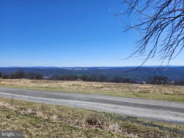 a view of an ocean beach and mountain