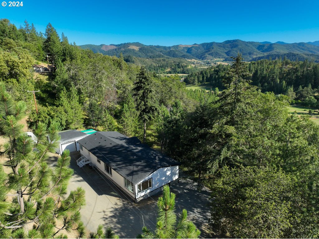 1069 Spring Brook Road Myrtle Creek, OR 97457 - Photo 1 of 43 a view of a backyard with mountain view