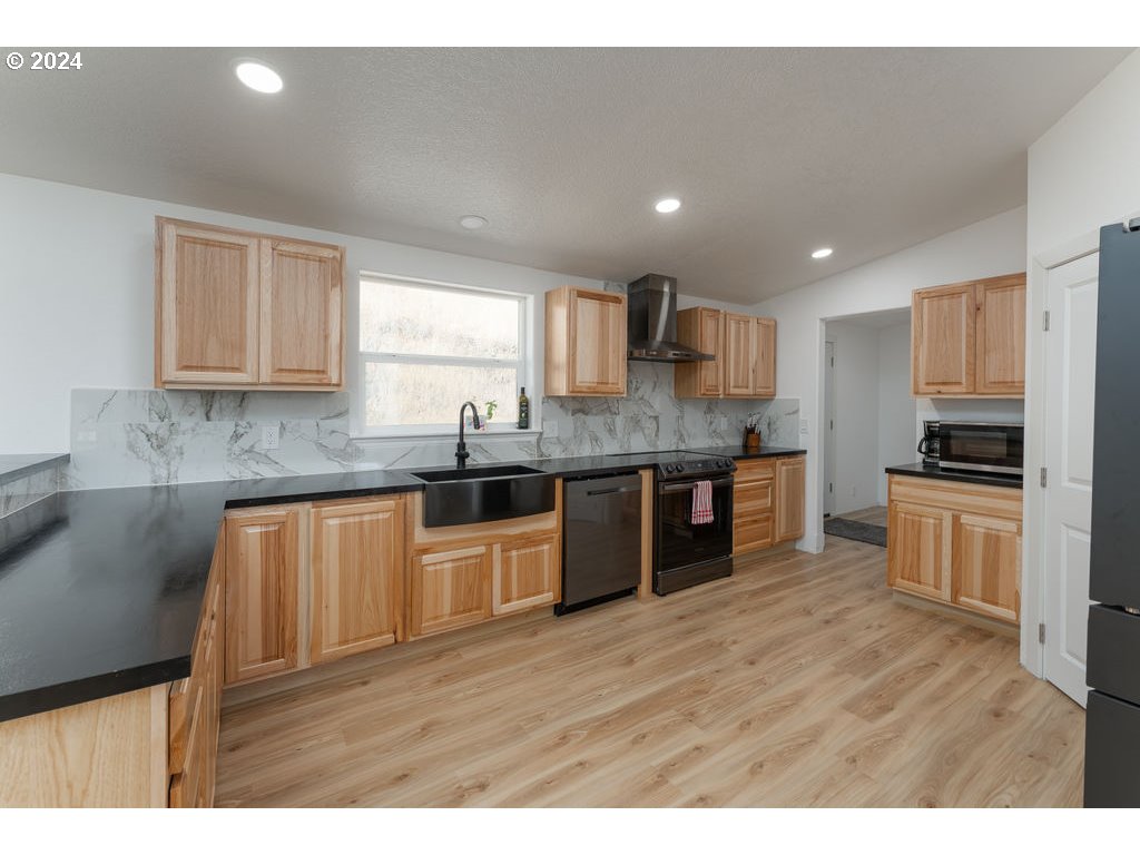 1069 Spring Brook Road Myrtle Creek, OR 97457 - Photo 13 of 43 a kitchen with stainless steel appliances granite countertop a stove sink and cabinets