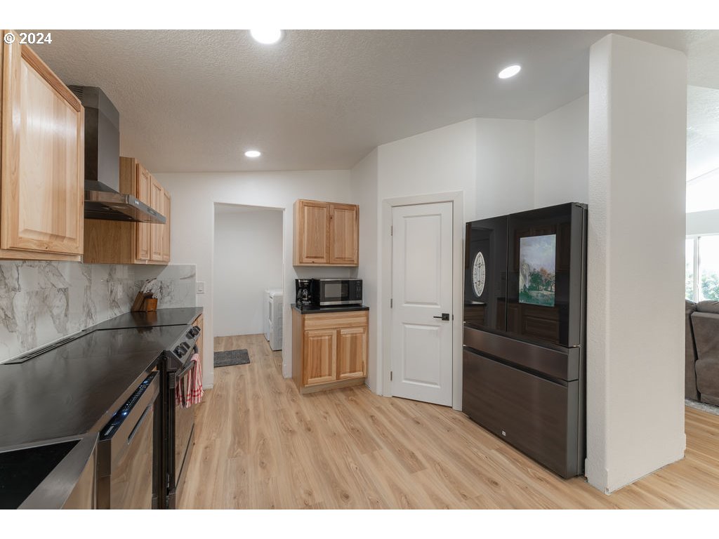 1069 Spring Brook Road Myrtle Creek, OR 97457 - Photo 15 of 43 a kitchen with a refrigerator and a sink
