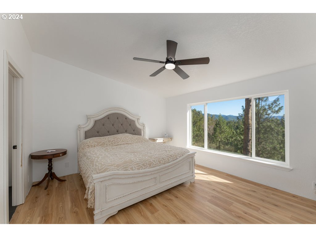 1069 Spring Brook Road Myrtle Creek, OR 97457 - Photo 17 of 43 a living room with a bed furniture and a window