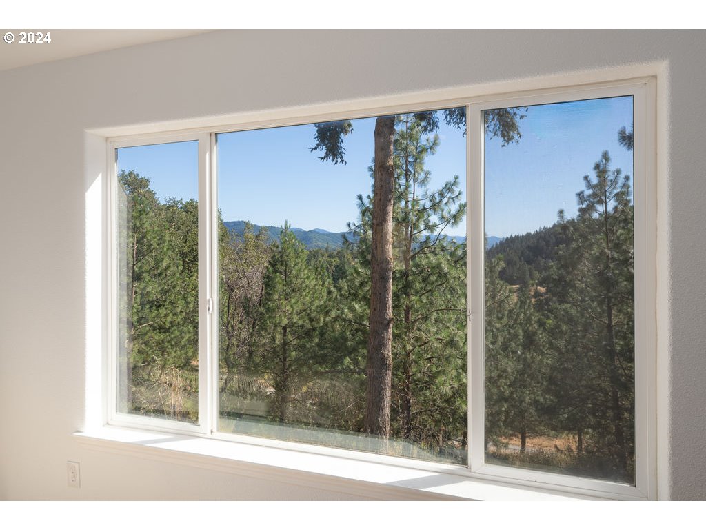 1069 Spring Brook Road Myrtle Creek, OR 97457 - Photo 18 of 43 a view of a glass door and a window