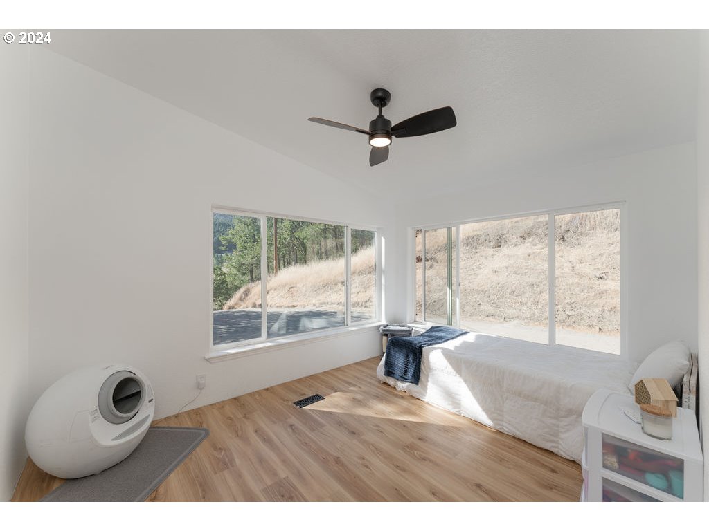 1069 Spring Brook Road Myrtle Creek, OR 97457 - Photo 22 of 43 a view of empty room with wooden floor and fan