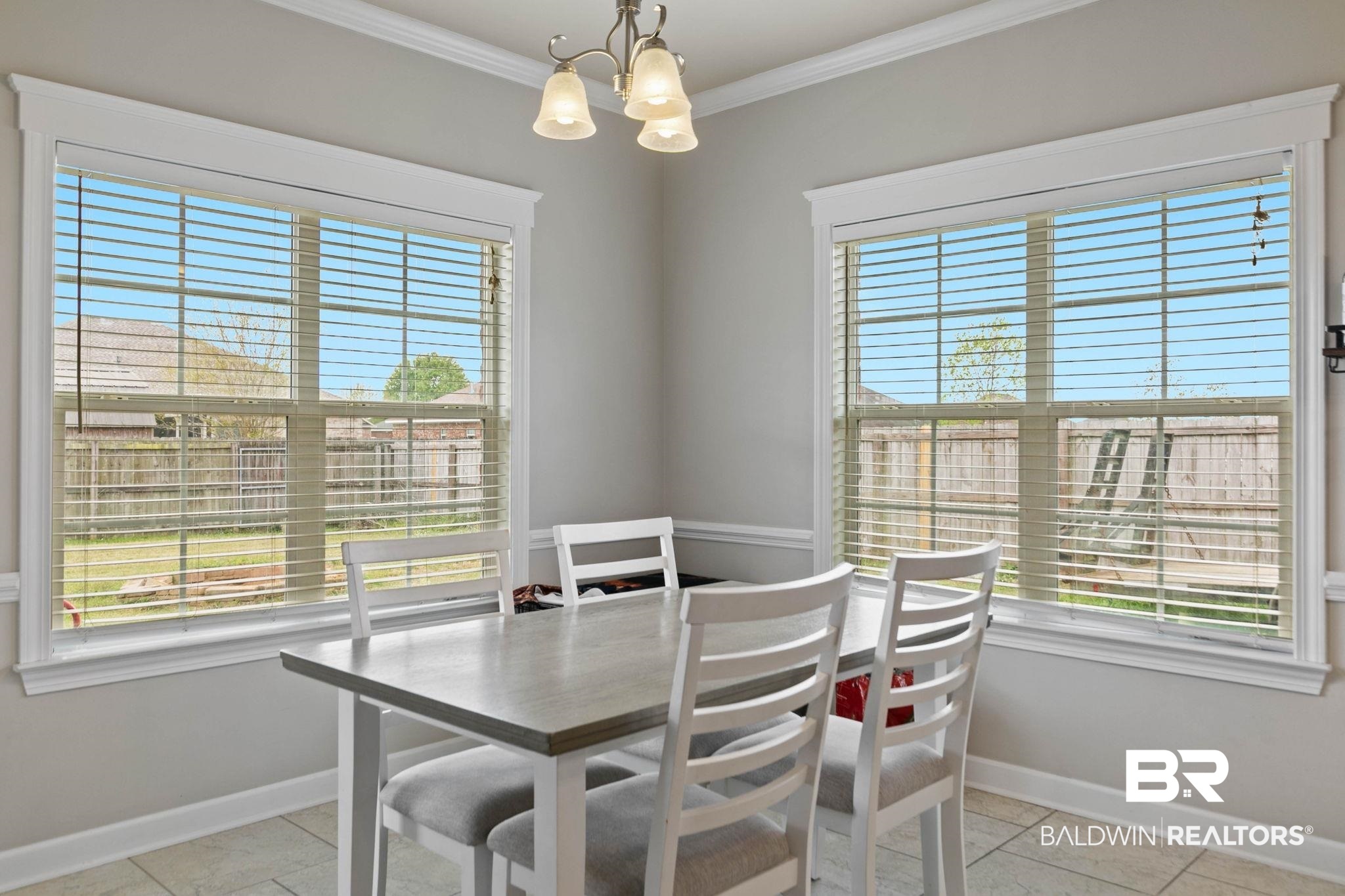 9177 Labrador Trail Theodore, AL 36582 - Photo 7 of 24 Dining area featuring hanging lights and crown molding