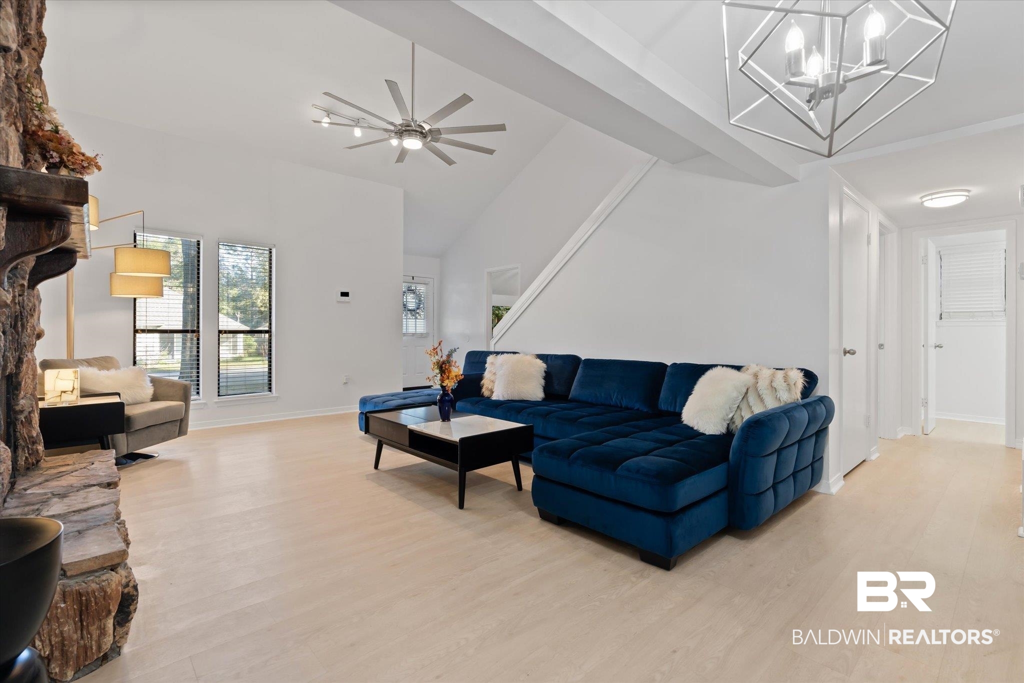 1008 Mcneil Avenue Mobile, AL 36609 - Photo 2 of 20 Living room with ceiling fan with notable chandelier, high vaulted ceiling, and light hardwood / wood-style flooring