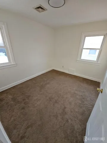 an empty room with a empty space and a window