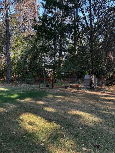 1833 Stringer Gap Road Grants Pass, OR 97527 - Photo 21 of 23 Fenced in garden area with raised beds and lots of fruit trees