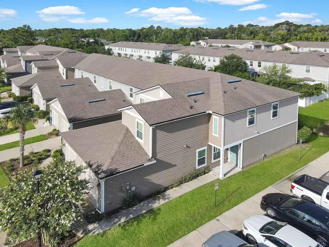 an aerial view of a house with pool a yard and outdoor seating