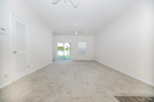 an empty room with window and pillar in it