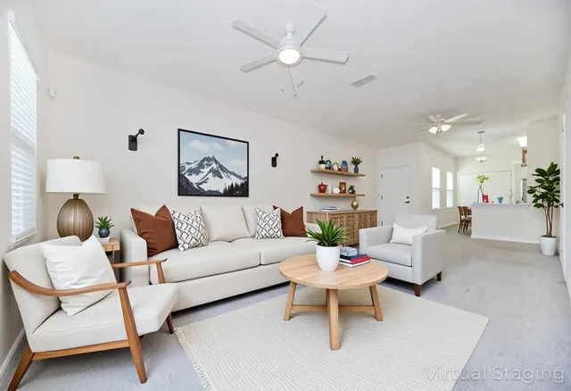 a living room with furniture and a chandelier