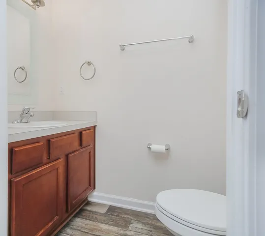 a bathroom with a sink a toilet and a mirror