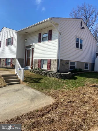 a view of a house with a yard and sitting space