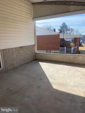 an empty room with wooden floor and a window