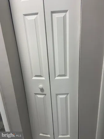 a view of a room with wooden floor and door